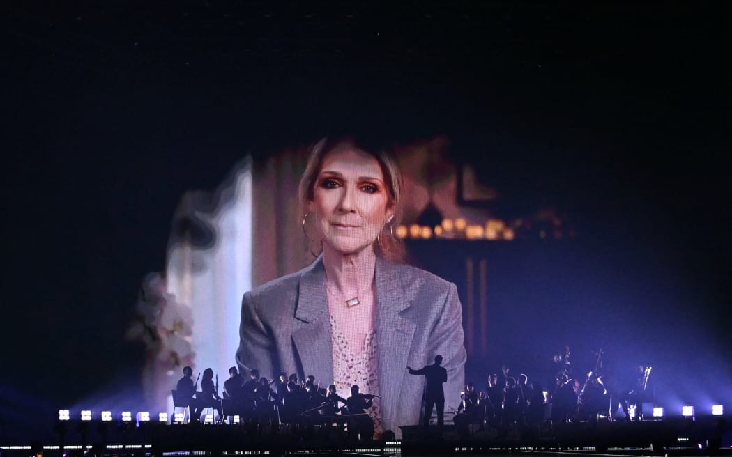 A screen shows Canadian singer Celine Dion giving a recorded message during the first semi-final of the Eurovision Song Contest 2025, at the St. Jakobshalle arena in Basel on May 13, 2025. (Photo by SEBASTIEN BOZON / AFP)