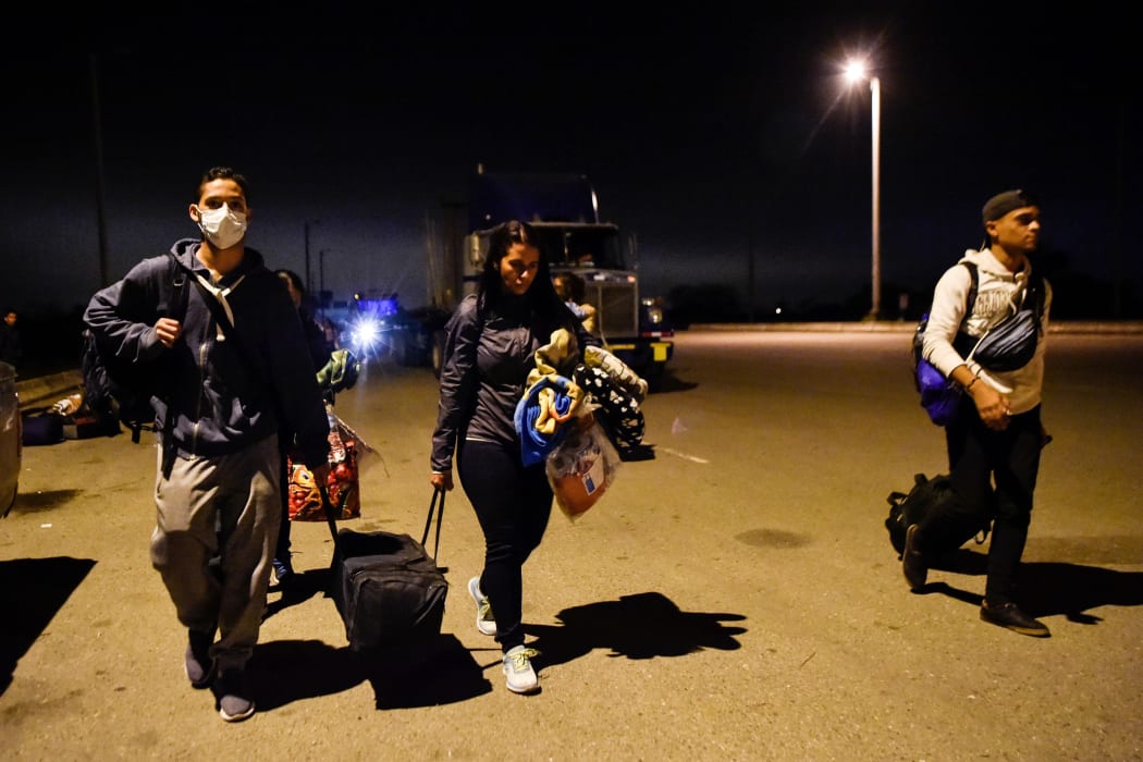 Venezuelan migrants cross the border between Ecuador and Peru in Tumbes, Peru after touring Ecuador in buses facilitated by the Ecuadorian authorities as part of a "humanitarian corridor" to facilitate their passage.