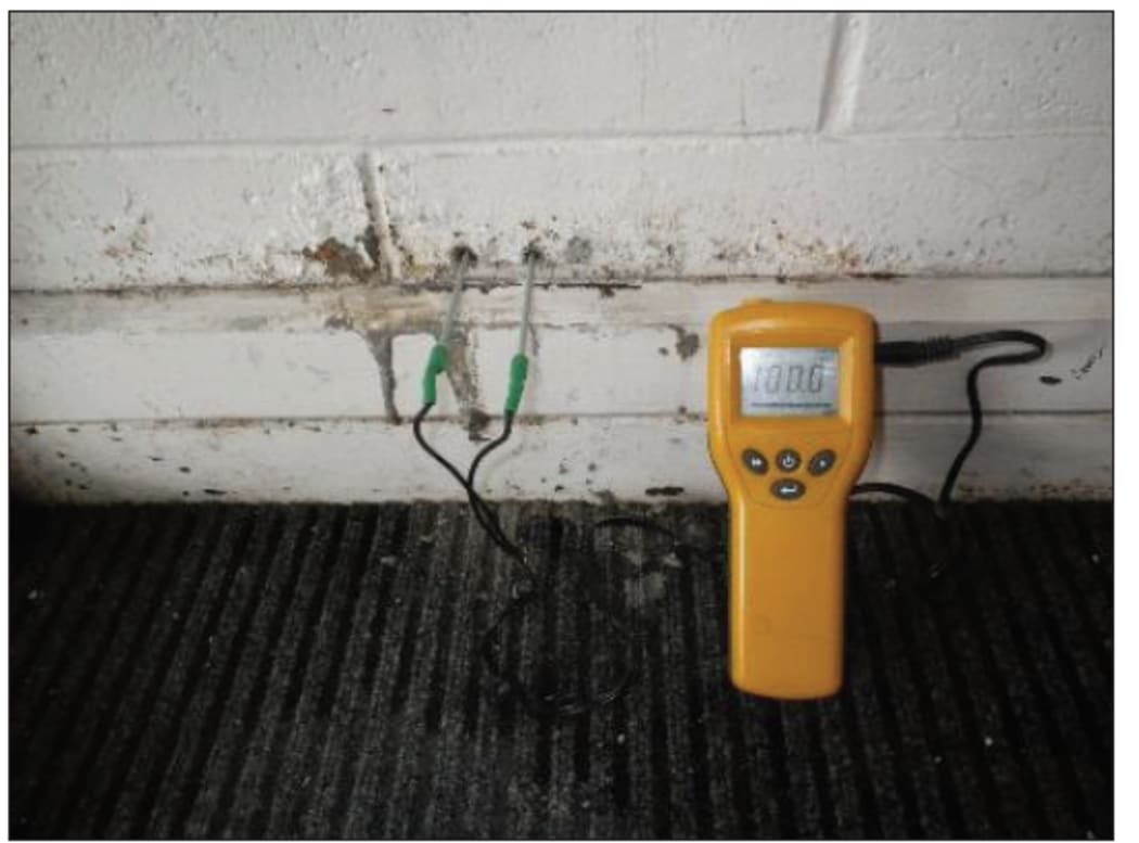 A moistiure meter shows concrete wet at the school.