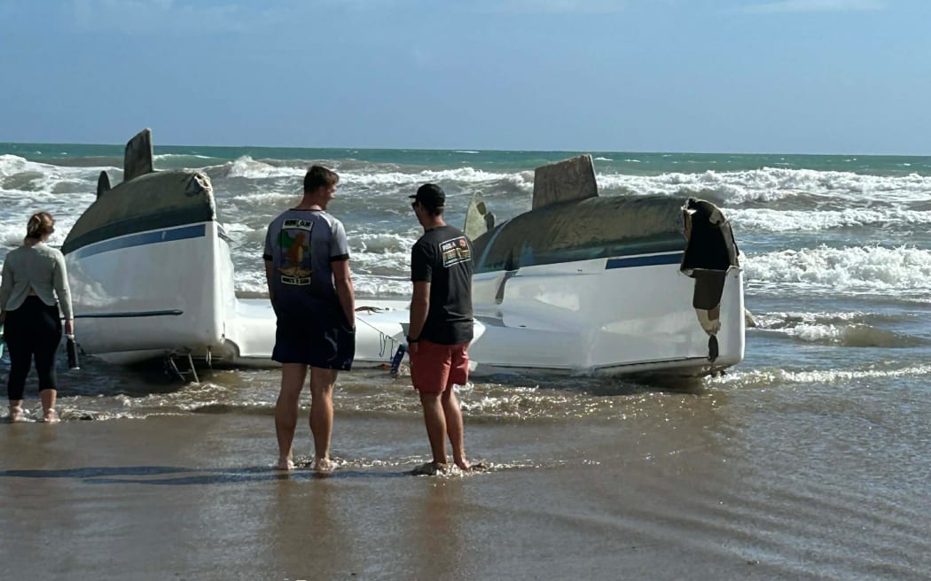 Rescuers came to the add of a capsized yacht on Sandy Bay Beach in Northland.