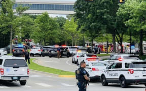 Police officers respond to a call about a man armed with a rifle at the Natalie Building at St. Francis Hospital in Tulsa, Oklahoma.