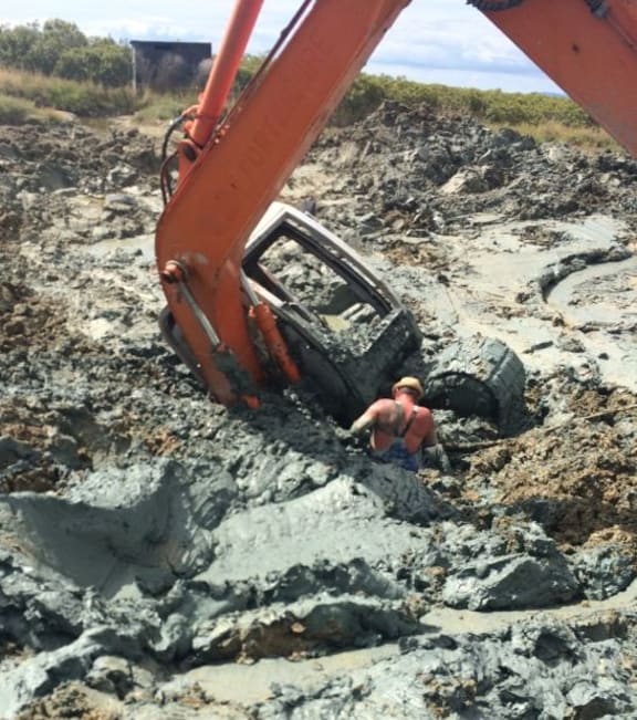 A borrowed digger got stuck in the wetland while digging the illegal pond.