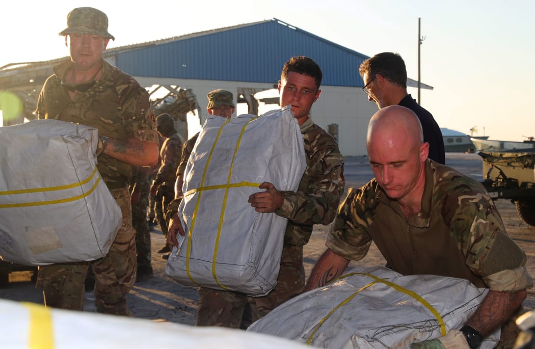 members of the Humanitarian and Disaster Relief (HADR) team from Royal Fleet Auxiliary (RFA) Mounts Bay delivering aid to the island Great Abaco in the northern Bahamas on September 6, 2019 in the aftermath of Hurricane Dorian.