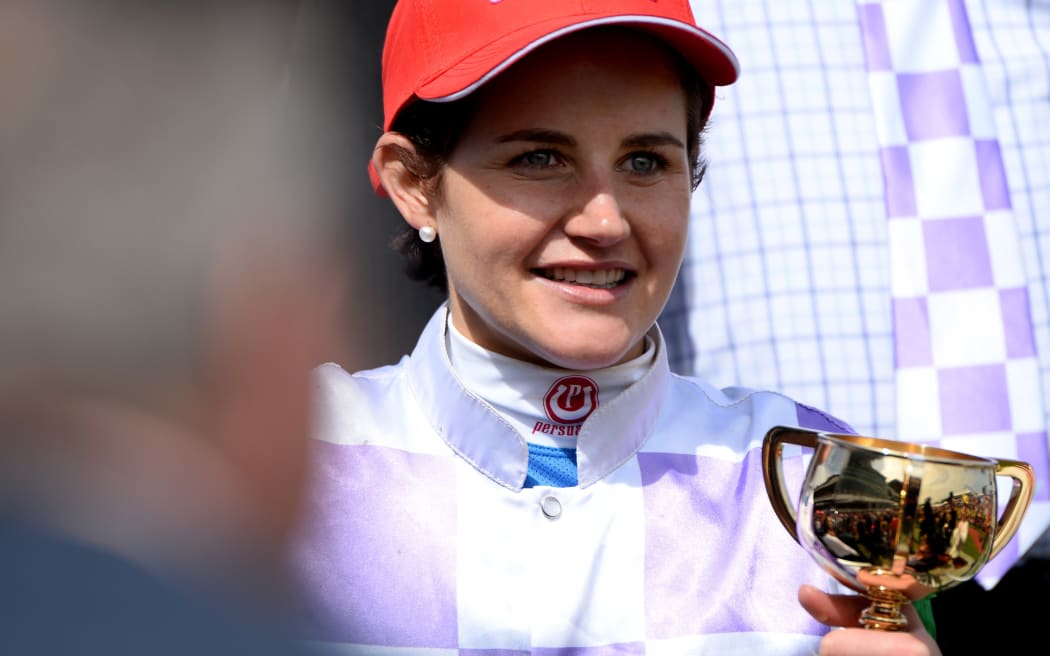 Michelle Payne holding the Melbourne Cup.