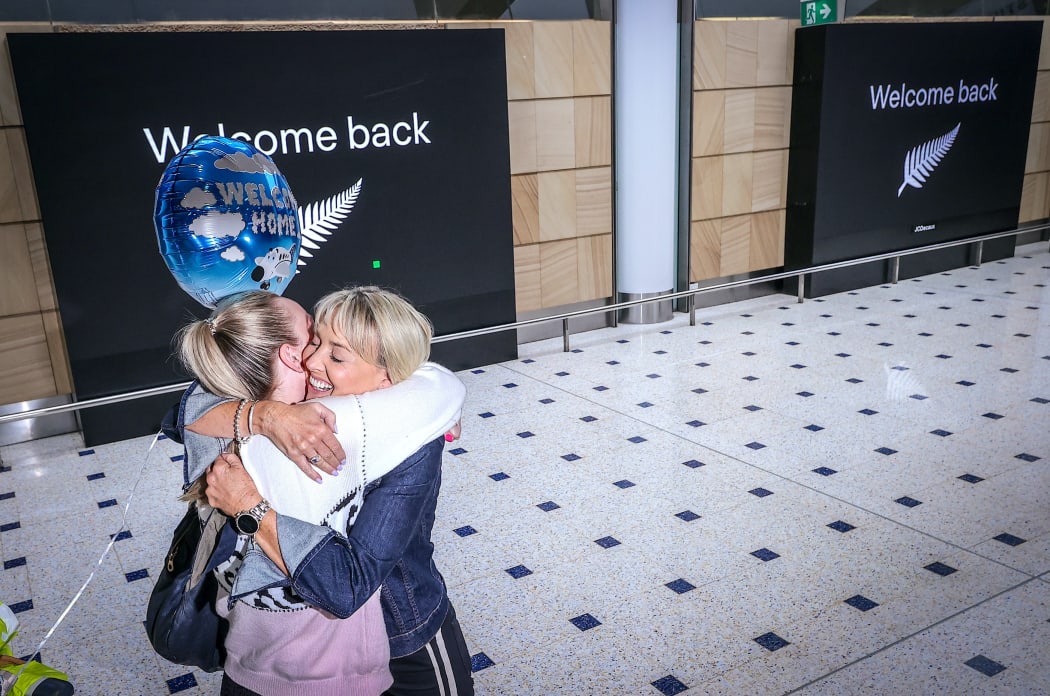A passenger hugs a family member on arrival from New Zealand at Sydney International Airport on October 16, 2020, after Australias border rules were relaxed under a new one-way trans-Tasman travel agreement that allow travellers from New Zealand to visit NSW without having to quarantine.