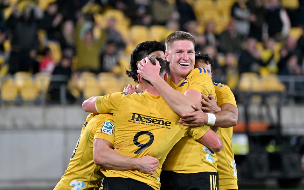 The Hurricanes celebrates after scoring a try.