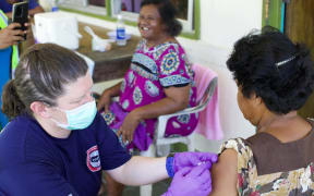 US Health officials administer the Johnson & Johson vaccine in Kayangel State