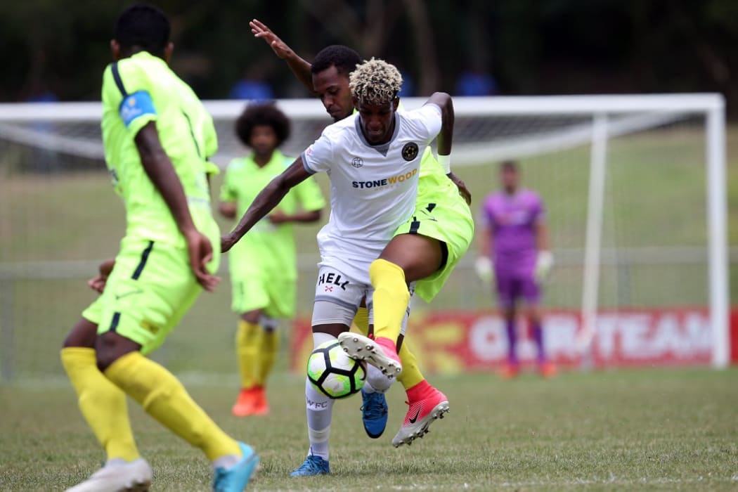 Team Wellington's Nathanael Hailemariam under pressure from Magenta defenders. CREDIT: OFC / phototek /Shane Wenzlick