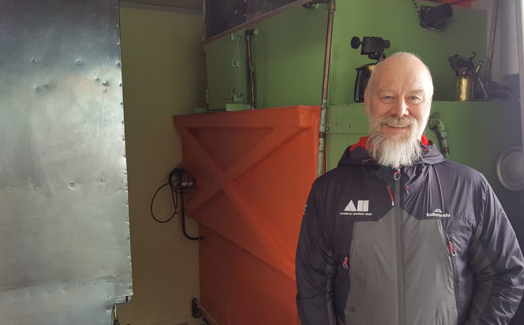 Conservator Al Fastier works for the Antarctic Heritage Trust. He is standing next to one of his favourite artefacts in Hillary Hut, also known as Hut A from the original Scott Base - the water-maker used to melt glacier ice.