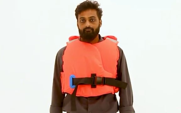 Massey doctoral graduate Areef Shaik models the lifejacket he designed especially for Indian flood rescuers