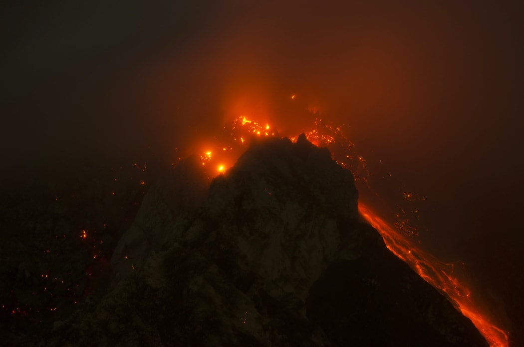 A long expoure photo shows Mount Sinabung on 14 June 2015.