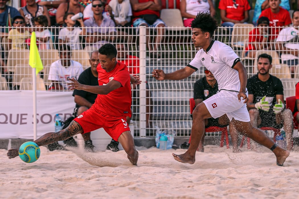 Tahiti's Gervais Chan Kat (Left) is pressured by a Tongan player at the OFC Beach Soccer Nations Cup 2019. Aorai Tini Hau, Tahiti, Tuesday 18th June 2019.