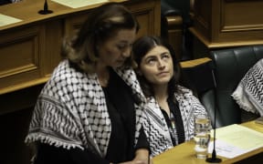 Chloe Swarbrick listens as Marama Davidson discusses the deaths in Gaza