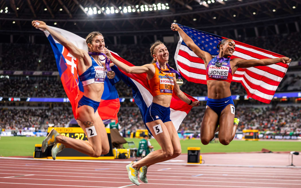 Femke Bol, centre, celebrates her win in the 400m hurdles race at the world athletics championships in Tokyo, with silver medallist Jasmine Jones, right, and Emma Zapletalova who was third. 20 Sept, 2025. Mandatory Credit ©INPHO/Morgan Treacy