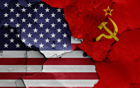 flags of USA and Soviet Union painted on cracked wall