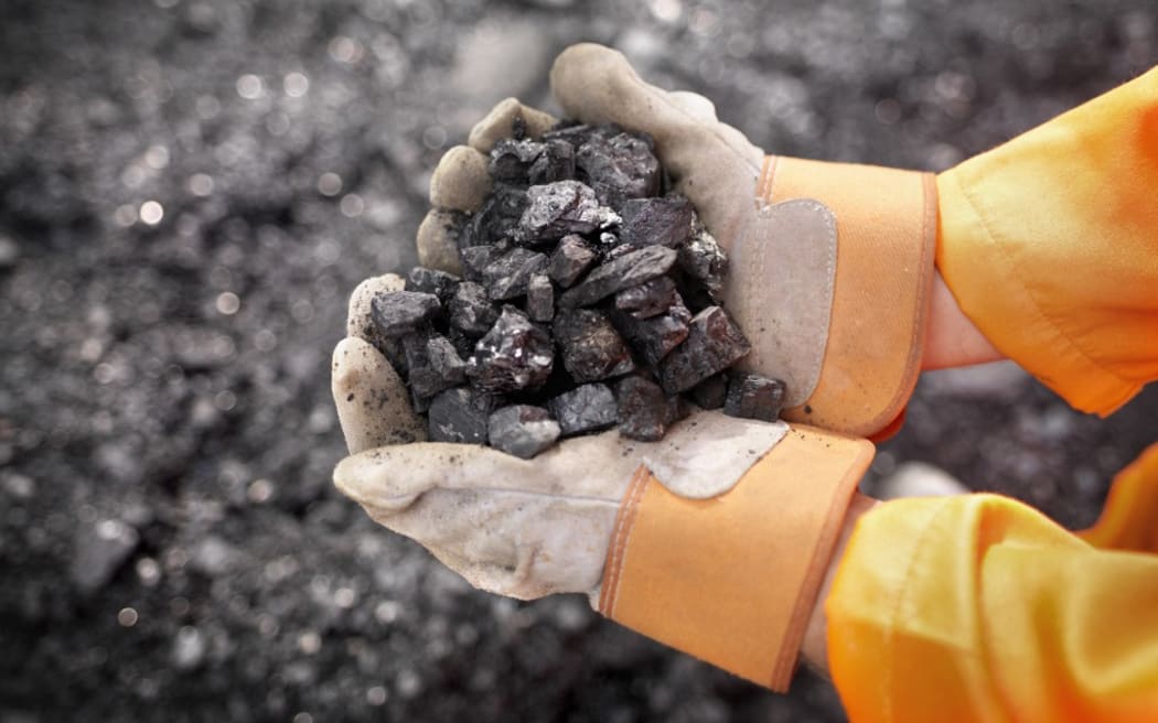 Coal Worker With Handful Of Coal (Photo by Monty Rakusen / Cultura Creative / Cultura Creative via AFP)