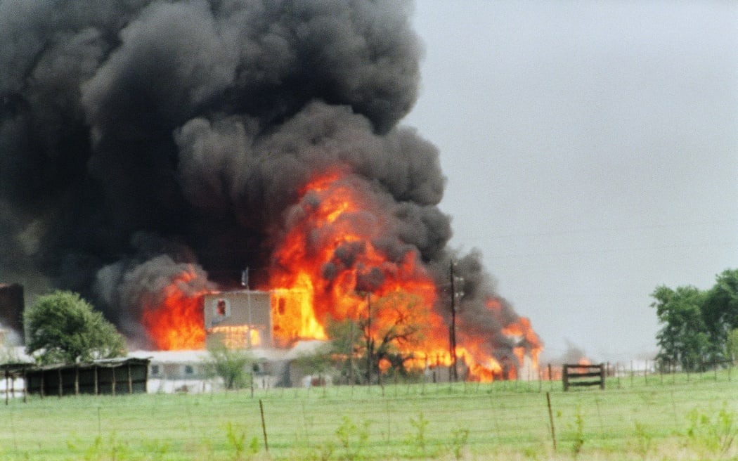 The Branch Davidian cult compound in Waco is engulfed in flames during the fire that claimed dozens of lives.