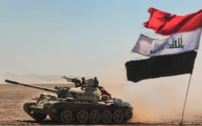 Tanks and armoured vehicles of the Iraqi forces, supported by the Hashed al-Shaabi (Popular Mobilisation) paramilitaries, advance towards the village of Sheikh Younis, south of Mosul, after the offensive to retake the western side of Mosul from Islamic State (IS) commenced on 19 February 2017.