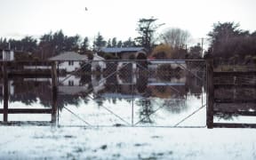 Floodwaters surround a farmhouse in mid Canterbury
