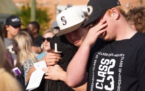 Mourners attend a vigil at the First Baptist Church of Dadeville following a mass shooting during a birthday party at the Mahogany Masterpiece dance studio in the city on 15 April, 2023, which left four people dead and 28 injured.