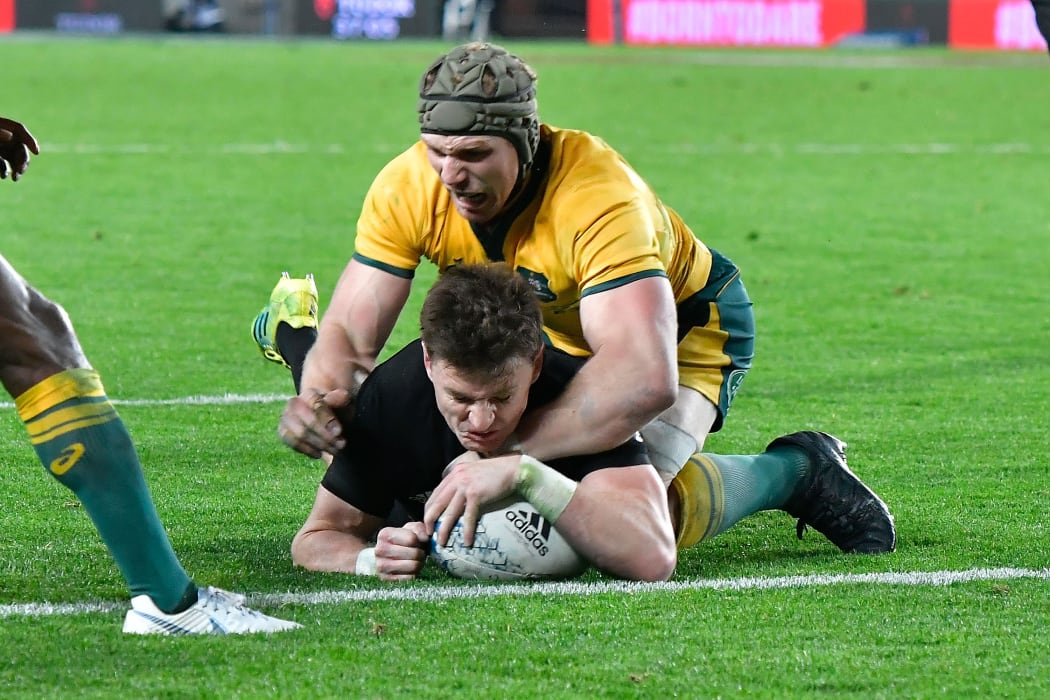 All Blacks Beauden Barrett scores a try with Australia's David Pocock during the 2nd All Black vs Australia Bledisloe Cup rugby match.