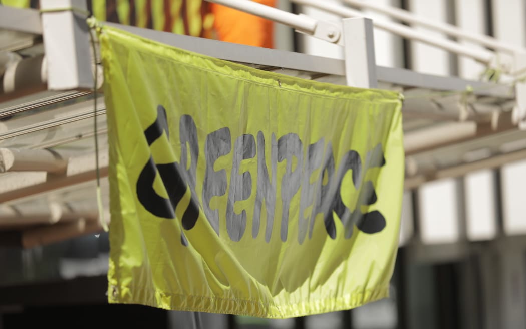 A Greenpeace banner hangs on an office building on The Terrace, Wellington, September 2024.