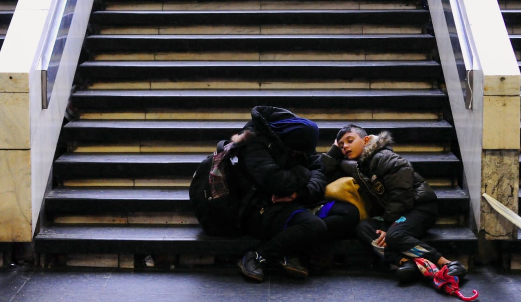 A family waits to board a train at Budapest's Keleti railway station.