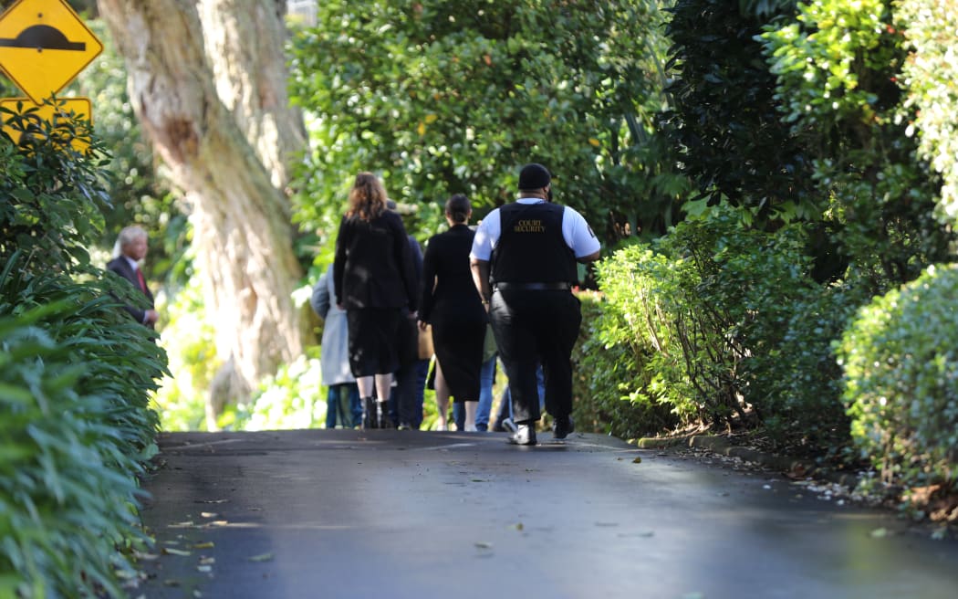 The jury entering the property from a side entrance.