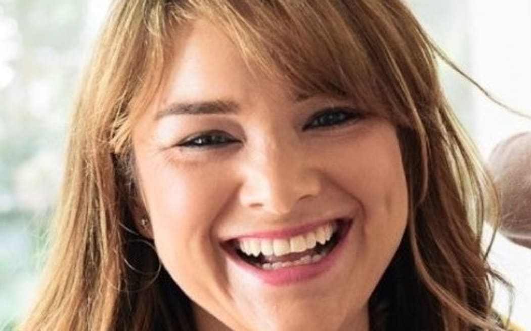 This is a headshoot of Rachael. She is smiling towards the camera. Her blonde hair falls around her face, framing her smile.