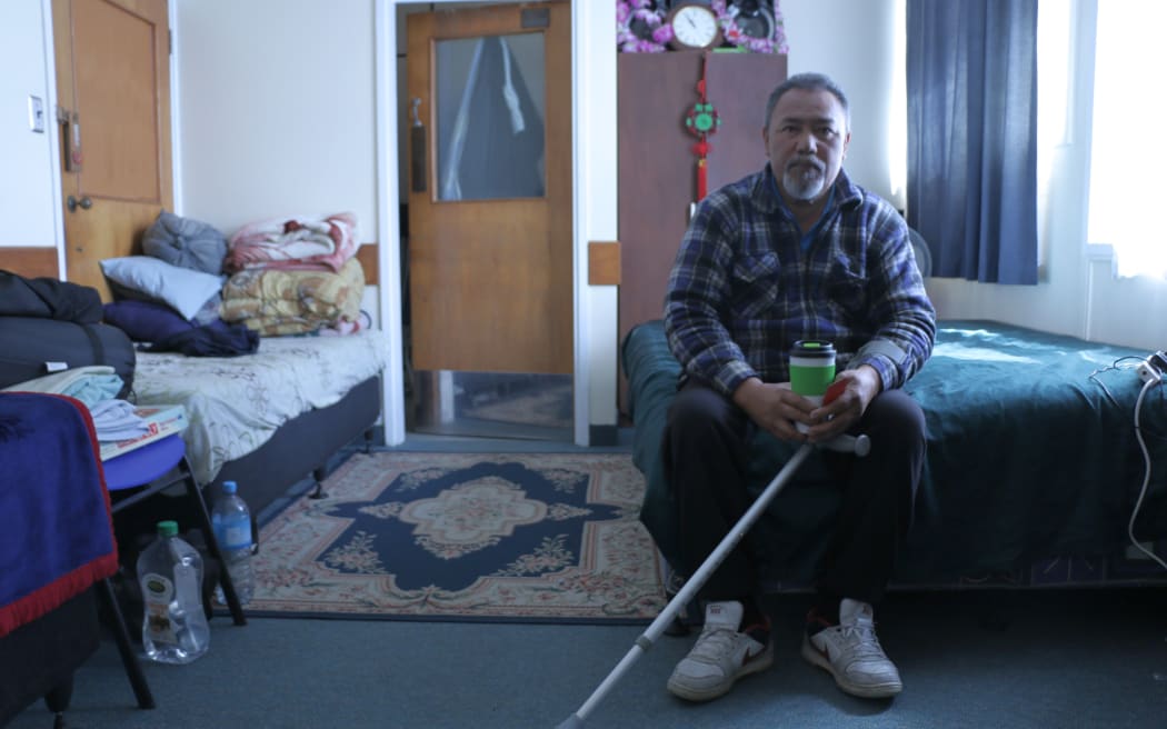 Raymond Teinaki in the room he shares with his wife and two young sons  at Favona Lodge.