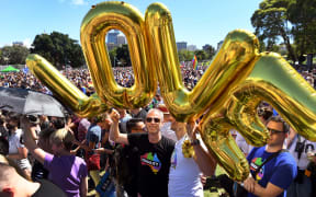 Supporters of the same-sex marriage "Yes" vote celebrate in a Sydney park shortly after the announcement.