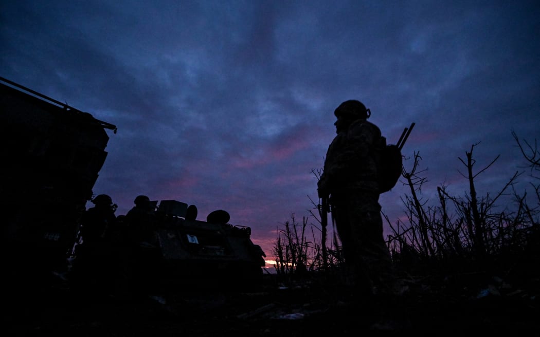 A serviceman from the 65th Separate Mechanized Brigade of the Ukraine army, at dusk in the suburbs of Robotyne, Zaporizhzhia Region, Ukraine, on 21 February, 2024.