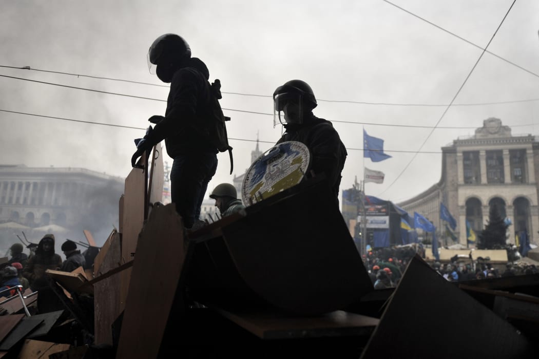 Protesters stand on barricades at Independence square in Kiev.