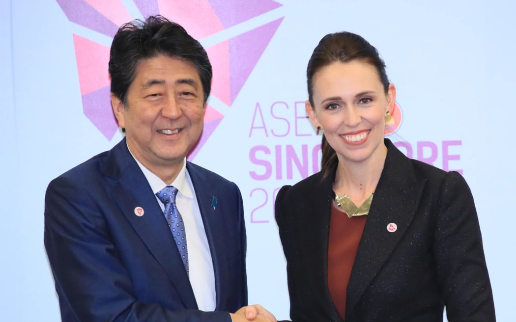 Japan's Prime Minister Shinzō Abe (L) shakes hands with New Zealand Prime Minister Jacinda Ardern prior to their summit meeting in Singapore.