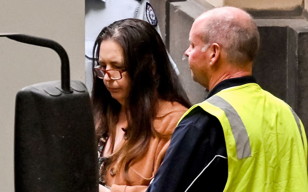 Convicted killer Erin Patterson (L) leaves the Supreme Court of Victoria in Melbourne on September 8, 2025. An Australian judge sentenced Patterson on September 8 to life in prison with parole after 33 years for killing three people with toxic mushrooms, capping a trial that sparked a global media frenzy. (Photo by William WEST / AFP)