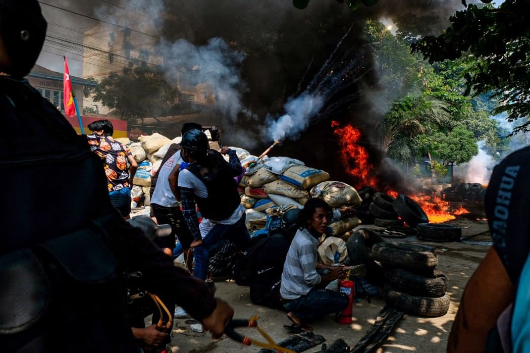 Smoke rises after protesters burn tyres as they gather to continue their protest against military coup.