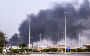 A plume of smoke rises from the Zayed Port following a reported Iranian strike in Abu Dhabi.