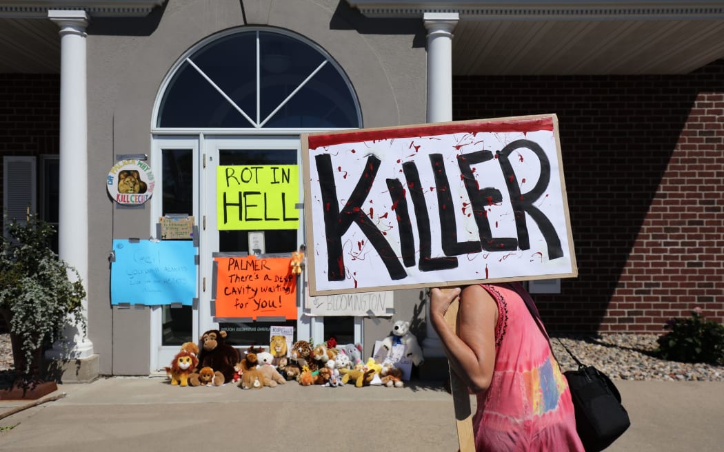 Protesters gathered outside Dr  Walter Palmer's clinic in Bloomington, Minnesota.