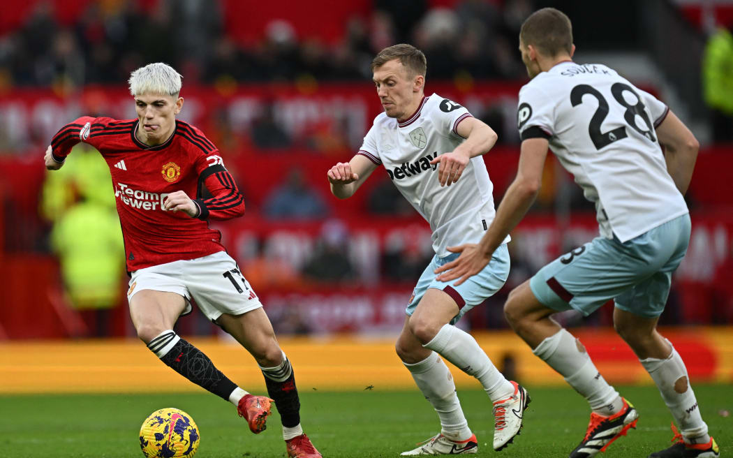 Manchester United's Argentinian midfielder #17 Alejandro Garnacho (L) controls the ball during the English Premier League football match between Manchester United and West Ham United at Old Trafford in Manchester, north west England, on February 4, 2024. (Photo by Paul ELLIS / AFP) / RESTRICTED TO EDITORIAL USE. No use with unauthorized audio, video, data, fixture lists, club/league logos or 'live' services. Online in-match use limited to 120 images. An additional 40 images may be used in extra time. No video emulation. Social media in-match use limited to 120 images. An additional 40 images may be used in extra time. No use in betting publications, games or single club/league/player publications. /