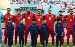 Iran players listen to the national anthem ahead of the Qatar 2022 World Cup Group B football match against England.