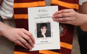 A mourner wearing a Gryffindor scarf holds an order of service as she arrives to attend the funeral service of journalist Lyra McKee (29) who was killed by a dissident republican paramilitary in Northern Ireland.