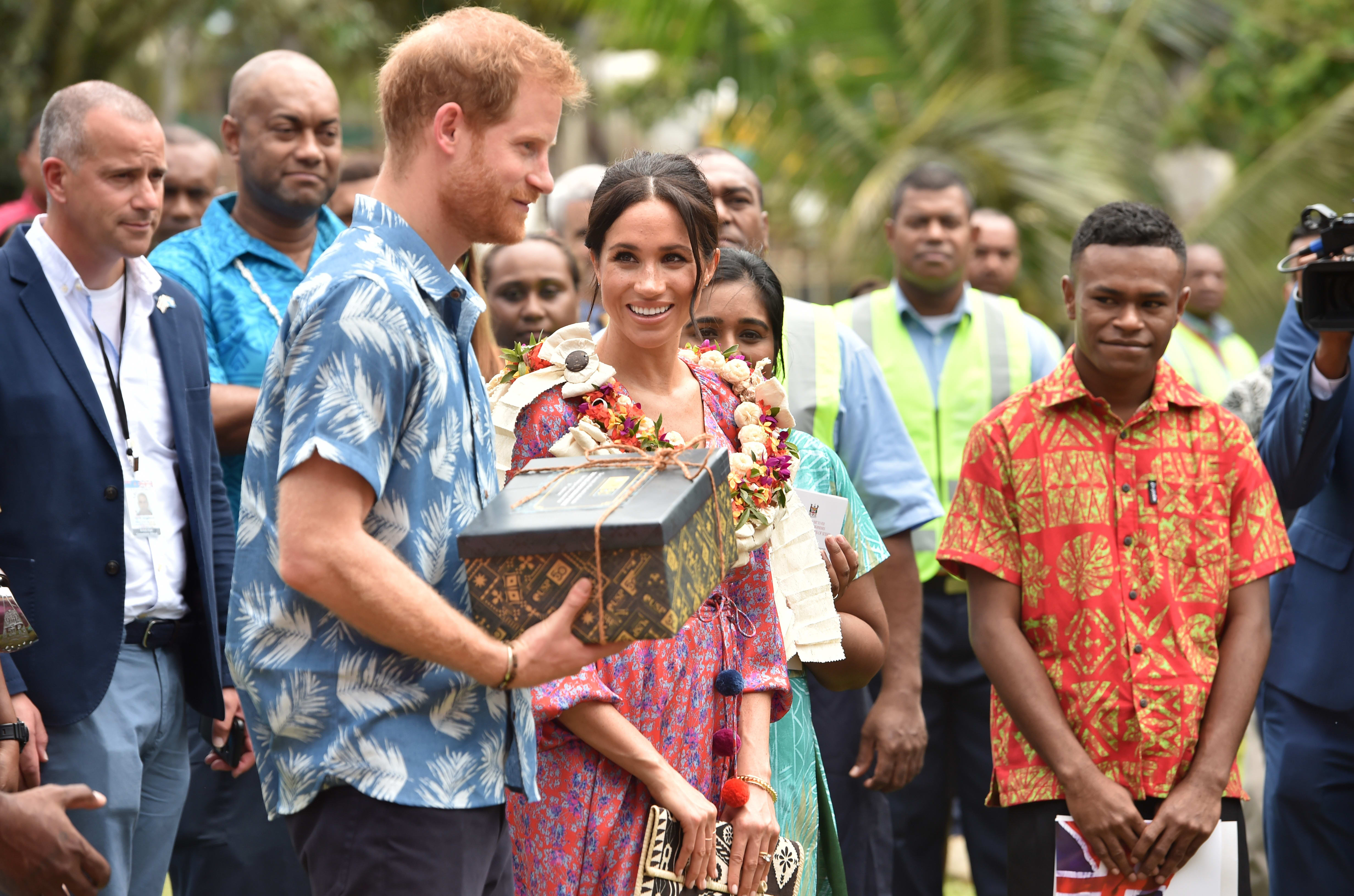 Britain's Prince Harry and his wife Meghan, Duchess of Sussex receive a gift from the University of the South Pacific in Suva.