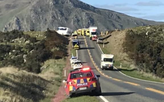One person is dead and nine injured after a crash between a car and bus south of Kingston this morning.