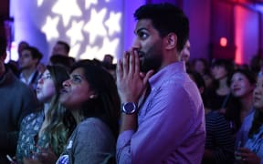 People react to live results while attending a midterm election night party hosted by the Democratic Congressional Campaign Committee in Washington, DC.