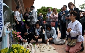 People pray outside the Fundacion Santa Fe clinic, where Colombian presidential candidate Miguel Uribe is hospitalized after being shot during a political event in Bogota on June 10, 2025. Right-wing senator and presidential candidate Miguel Uribe is in intensive care, and his condition is stable but critical, according to the latest medical report. (Photo by Raul ARBOLEDA / AFP)