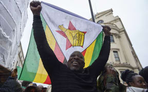 Demonstrators protest outside the Zimbabwe Embassy in London.