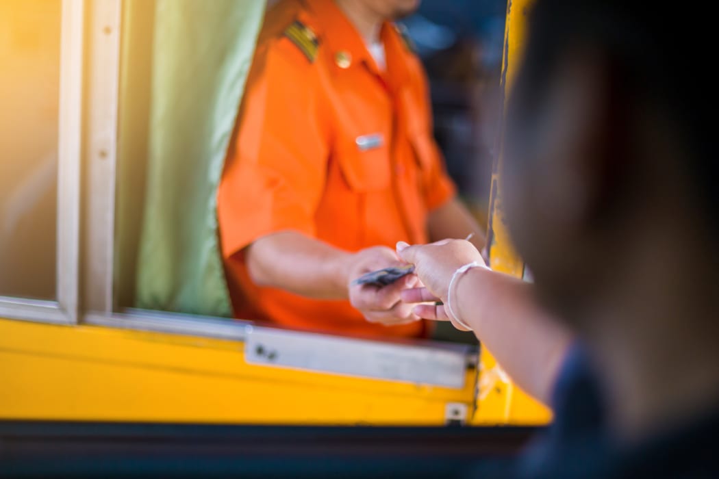 Driver pay for the expressway. Man pays money to a cashier for a toll road toll gate motorway entrance.