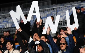 Joseph Manu's family and friends show their support for the Kiwis centre.