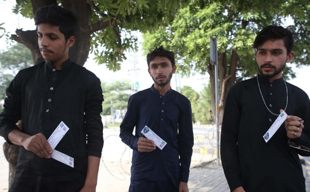 RAWALPINDI, PAKISTAN, SEPTEMBER 17: Pakistani spectators show tickets following the cancellation of cricket series between Pakistan and New Zealand, in Rawalpindi, Pakistan, on September 17, 2021.