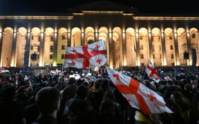 Georgian opposition supporters rally calling for government to follow 'pro-Western' path, outside the parliament in Tbilisi on 9 March, 2023.
